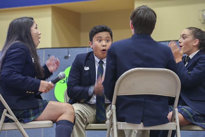 The eighth-grade Battle of the Books team from St. Joseph School, Athens, (l-r) Daphne Crawford, Jude Paradela, Patrick Holmes and Rachel Duncan successfully answer a question to push the competition beyond the customary five rounds. St. Joseph defeated host school, St. Catherine of Siena, 21-18 in an epic 10-round clash. Photo By Michael Alexander