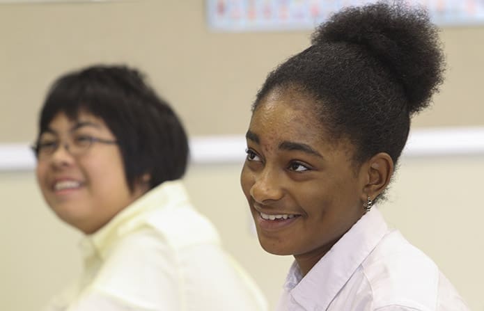 Anxiety and misgiving are replaced by relief among the students, in the way of smiles, throughout John Henry Spann’s classroom, including Tristan Fernanted, left, and Kelsey Benoit. Photo By Michael Alexander