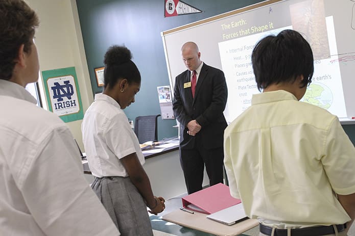 This was the very first time the high school students and teachers stood for morning prayer at the end of the first class block. They will also end each day at 3:30 p.m. with afternoon prayer. Photo By Michael Alexander