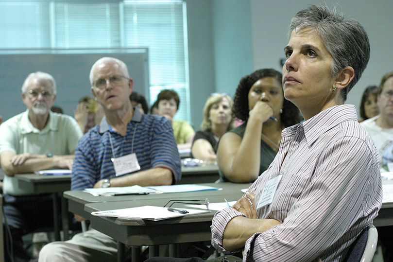 Like faces of many in the Social Action Summer Institute audience, Ginger Cashin, a member of the Shrine of the Immaculate Conception, Atlanta, listens with disbelief as Nathalie Piraino, a survivor of the Rwandan genocide, shares her personal stories of loss and survival during the horrific period of racism and ethnic cleansing. Photo By Michael Alexander