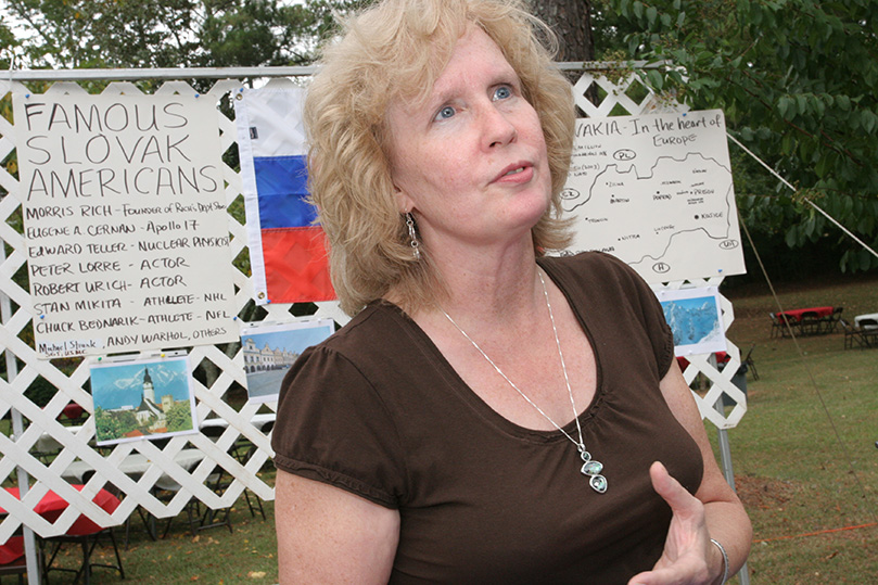 Sue Nemchick stands before the Slovak booth, one of many food stations that were available to people following Mass. Photo By Michael Alexander