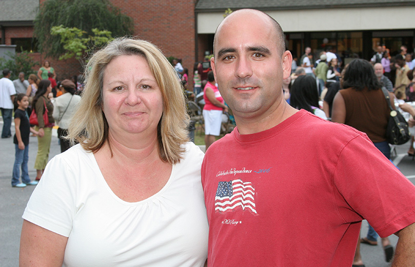 Kathy Cirincione, left, parish director of activities, has coordinated the multicultural festival for nine of the 10 years. John Bush, the parish facilities manager, helps with the set up. Photo By Michael Alexander