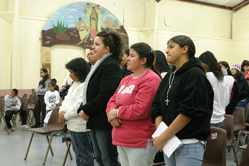 (L-r) Gloria Vazquez, Margarita Cervantez, Etelvina Garcia and her daughter Nayeli Perez stand during a sendoff prayer for the pilgrims at Our Lady of the Americas Mission, Lilburn. Photo By Michael Alexander