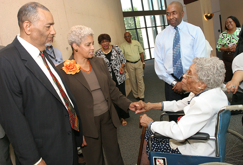 Waiting outside the Atlanta City Council chambers, Nettie Singleton, right, gets a birthday greeting from Atlanta mayor Shirley Franklin as she walks down the hall. Photo By Michael Alexander