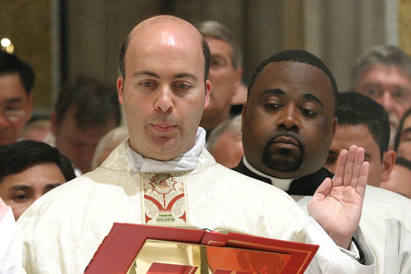 Father Nicholas Azar reads a prayer during the Liturgy of the Eucharist from the Sacramentary. Photo By Michael Alexander