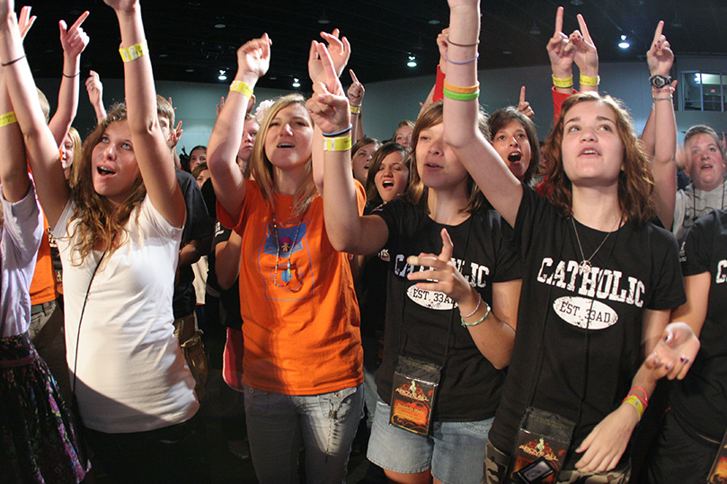 Teens gather at the front of the stage inside the Gwinnett Conference Center as Matt Maher and his band perform. Photo By Michael Alexander