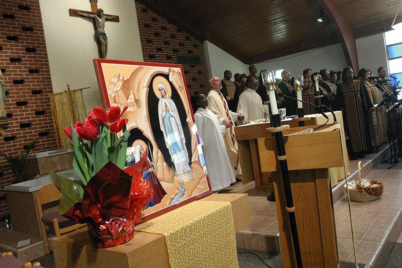 The Our Lady of Lourdes Catholic community celebrates its parish feast day during Mass last February. Photo By Michael Alexander