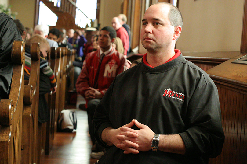 Our Lady of Mercy High School principal Danny Dorsel kneels in prayer during the Liturgy of the Eucharist at the Jan. 22 Mass for the Unborn. Photo By Michael Alexander