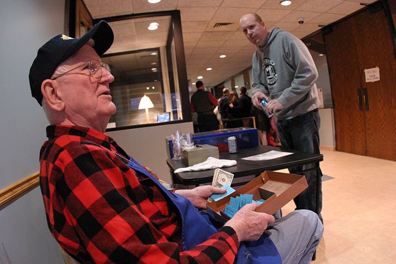 Kenneth Winkler catches patrons coming through the front door who may be interested in the fish fry's 50-50 raffle. Winkler has been a parishioner since 1993. Photo By Michael Alexander