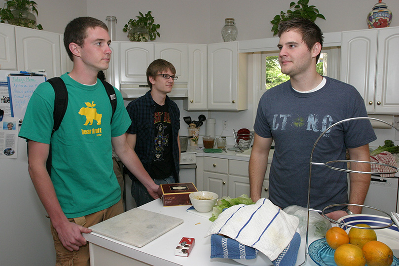 (L-r) Sophomore Joey Lyons from Marietta, junior Joey Zazeski from Rockville Centre, N.Y., and sophomore Brian McNavish from Pittsburgh, Pa., gather in the kitchen before Mass and lunch. Photo By Michael Alexander