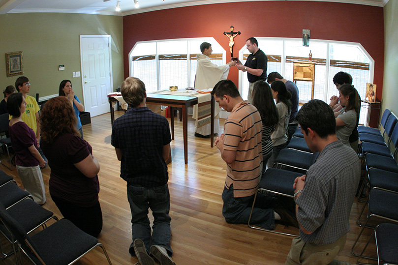 A congregation of nearly 25 people attends Mass at the Kennesaw State University Catholic Center, April 15. Photo By Michael Alexander