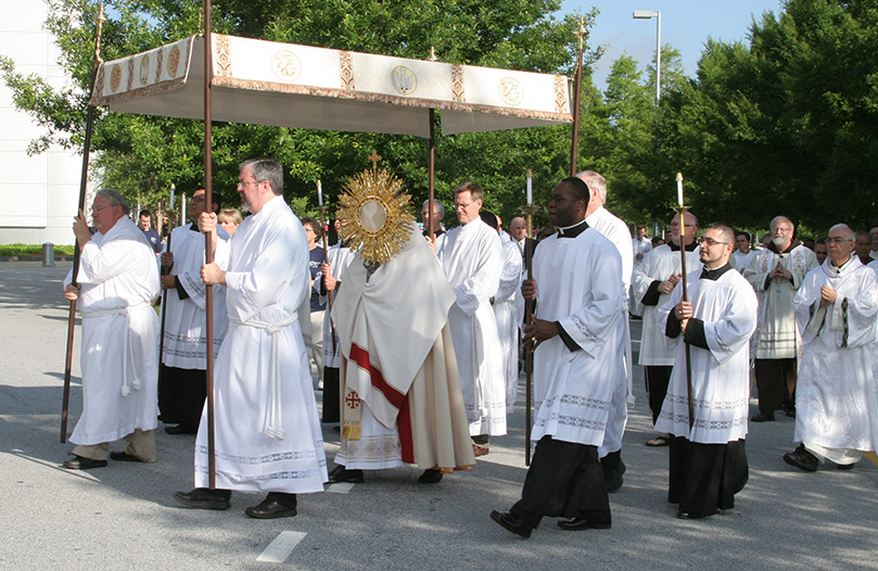 Archbishop Wilton D. Gregory carries the body of Christ as he leads the morning procession from outdoors into the main exhibit hall of the Georgia International Convention Center, College Park. Photo By Michael Alexander