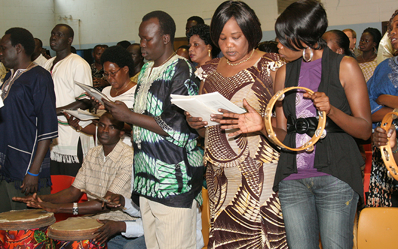 Members of the Sudanese choir at Corpus Christi Church, Stone Mountain, sing the opening hymn. The choir, which originally formed in 2000, is under the direction of Philemon Gor. Photo By Michael Alexander