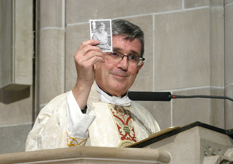 âI never get into a pulpit without her beside me. With her on one side and St. Theresa on the other side, I am invincible,â said homilist Father Richard Lopez, as he held up a memorial prayer card of Grey Nun of the Sacred Heart Sister Rita Raffaele. She worked for 34 years in the Archdiocese of Atlanta before here death in 2004. Photo By Michael Alexander