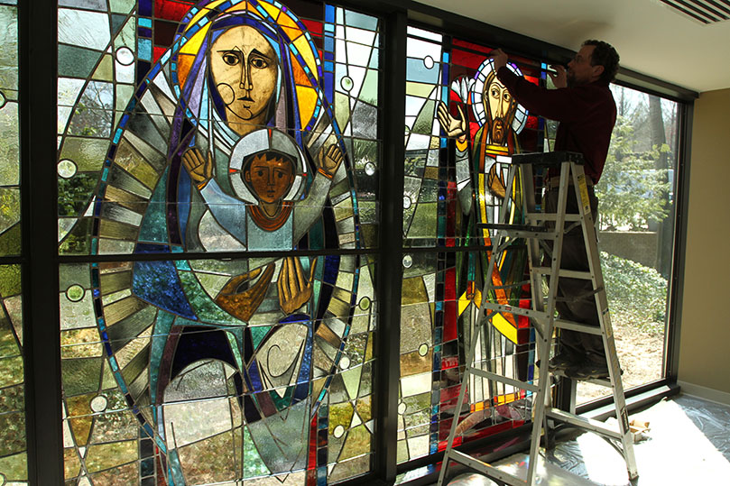 Frei attaches the aluminum stops along the top portion of the window. Photo By Michael Alexander