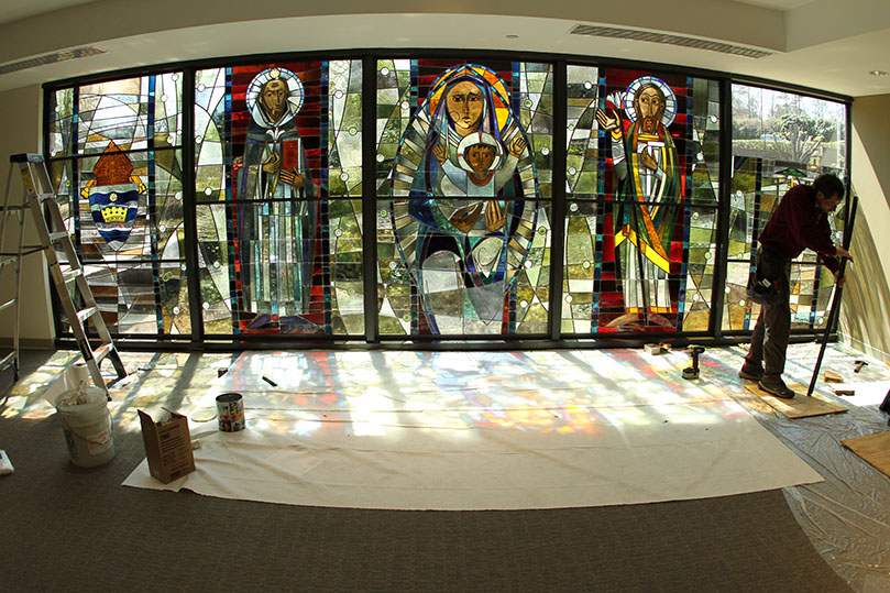 David Frei prepares to install the steel reinforcing bar to the Coat of Arms window. Photo By Michael Alexander