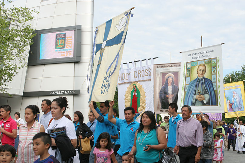 Throngs of people process toward the east entrance of the Georgia International Convention Center during the procession. Photo By Michael Alexander