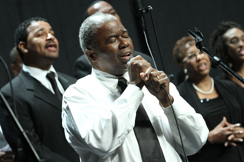 Ronnell Shaw of Sts. Peter and Paul Church, Decatur, leads the choir in singing the Richard Smallwood composition, “Jesus, You’re the Center of My Joy.”  Photo By Michael Alexander