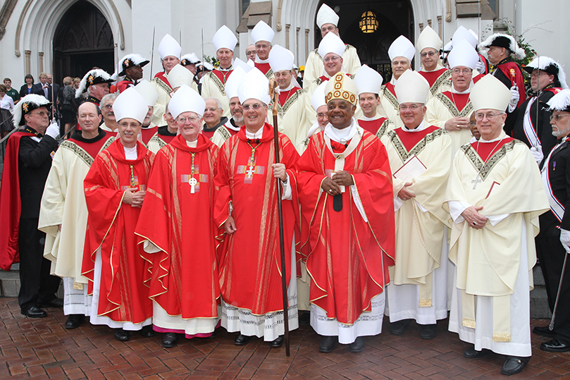 Exiting the Cathedral of St. John the Baptist, (front row, l-r) Bishop Luis Zarama, Auxiliary Bishop of Atlanta, J. Kevin Boland, Bishop emeritus of Savannah, Archbishop Wilton D. Gregory of Atlanta, and Bishop Gregory John Hartmayer, the new Bishop of Savannah, stop for photos with their brother bishops who were in attendance for the Hartmayer's episcopal ordination and installation. Photo By Michael Alexander