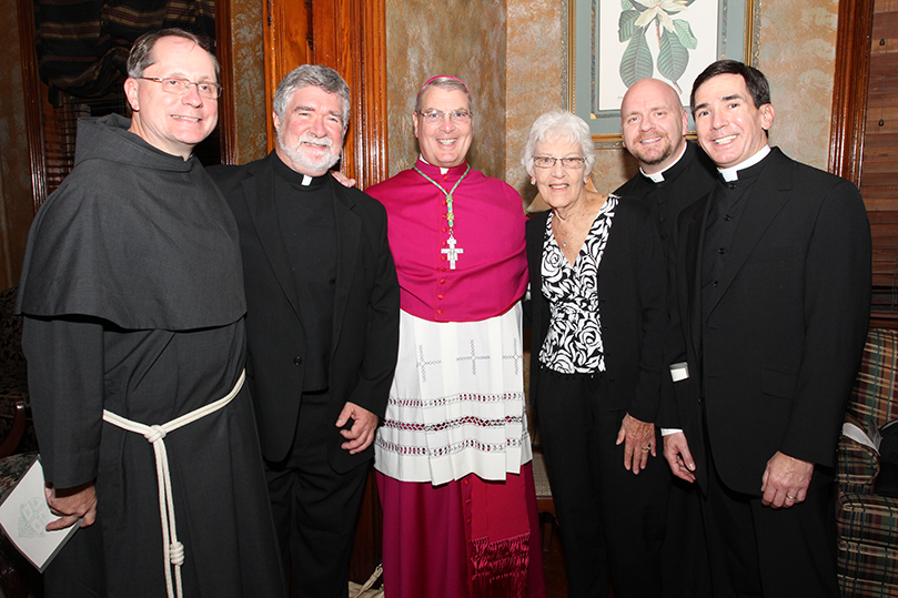 Bishop-elect Gregory John Hartmayer, third from left, takes a photo in the Cathedral of St. John the Baptist rectory with (l-r) Conventual Franciscan Father john Koziol, pastor of St. Philip Benizi Church, Jonesboro, Father Thomas Meehan, rector of Basilica of the Sacred Heart, Atlanta, his mother Sally of Tonawanda, N.Y, Father Victor Galier, pastor of St. Anthony of Padua Church, Atlanta, and Marist Father Paul Hachey, judicial vicar court of appeals, Archdiocese of Atlanta. Photo By Michael Alexander   