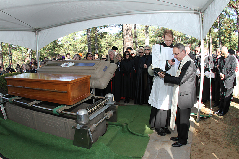 Assisted by Father Theodore Book, master of ceremonies, Bishop Luis Zarama, auxiliary bishop of Atlanta, conducts the prayer during the burial rite at Arlington Memorial Park, Sandy Springs. Photo By Michael Alexander