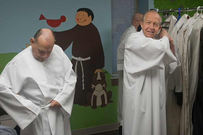 Candidates Jose Ortiz, left, and Dennis Carazza get ready to join eight other men to be ordained to the permanent diaconate, Feb. 11. Photo By Thomas Spink/Archdiocese of Atlanta