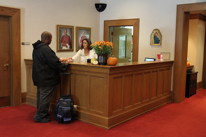 Front desk receptionist Rita Flynn provides a snack pack to Vietnam veteran Larry Gary. His disability doesn't provide enough to supplement his food needs, so he stops by the Cathedral of Christ the King to pickup a snack pack, which includes soup, crackers and fruit. The parish has been passing the packs out for eight years under the auspices of the Stewardship/Time and Talent Office.