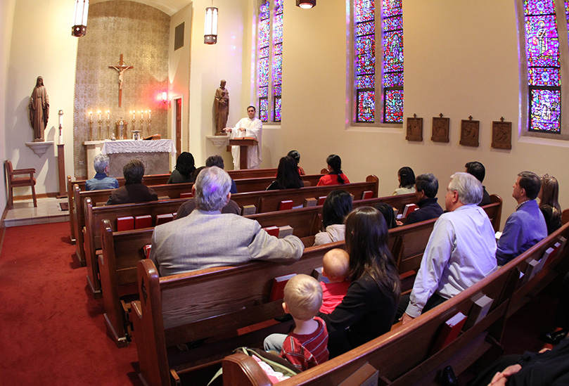 Parochial vicar Father Michael Silloway delivers a homily during the 5:30 p.m. Mass in the school's DâYouville Chapel. Mass is held in the chapel Monday through Friday.