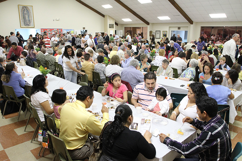 Parishioners and guests gathered in the parish hall for food and fellowship following the March 26 anniversary Mass. Photo By Michael Alexander