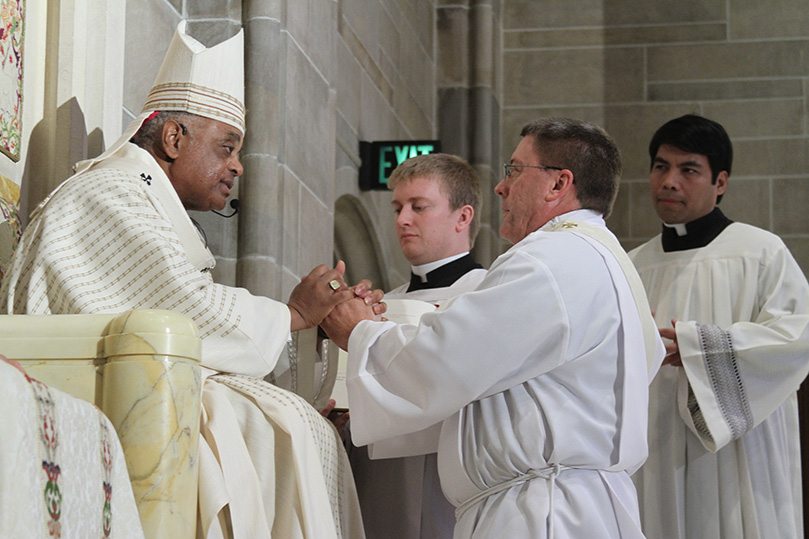 Ordination candidate Mark Starr pledges his obedience and respect to Archbishop Gregory and his successors. Photo By Michael Alexander