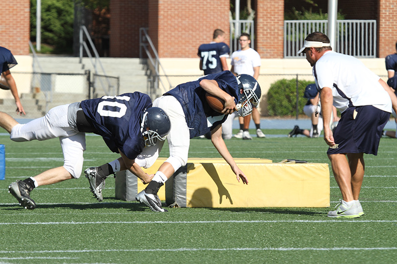 Defensive coordinator and defensive backs coach Jef Euart oversees a tackling drill during a September afternoon practice. The team is currently 8-1. Photo By Michael Alexander