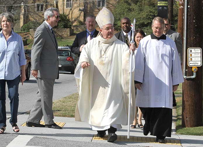 Auxiliary Bishop David Talley prepares to cross West Wesley Road on his way back to the Cathedral of Christ the King after visiting the overflow crowd at Second-Ponce de Leon Baptist Church. Photo By Michael Alexander