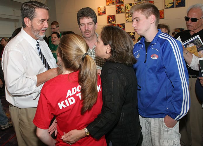 After signing one of his books, Scott Hahn, Ph.D., left, converses with the (clockwise, from top) David Abbamonte, his son Joseph, his wife Monica and his daughter Ana. The Abbamonte family attend St. Catherine of Siena Church, Kennesaw.