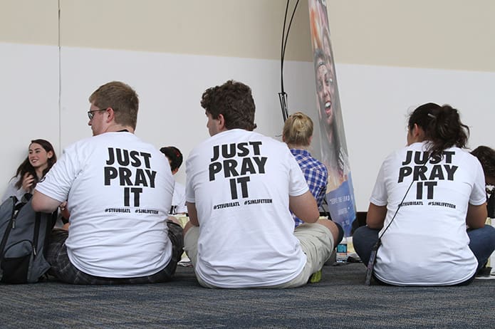 (L-r) Core member Jason Gambon and teens Benji Irlik and Nicki Grosch hang out in the hall during lunch. The three were among a group of Steubenville Atlanta attendees from St. John Neumann Church in Lilburn. Photo By Michael Alexander