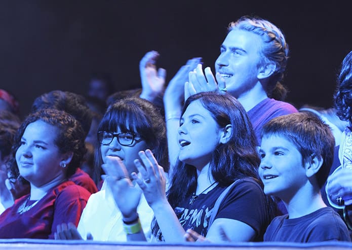 Standing under the stage lights (l-r) Rachel Grunkemeyer, 18, Vanessa Benitiz, 19, Rebekah Smock, 17 and Alec Pienta, 18, second from right, background, enjoy the afternoon entertainment following lunch. Photo By Michael Alexander