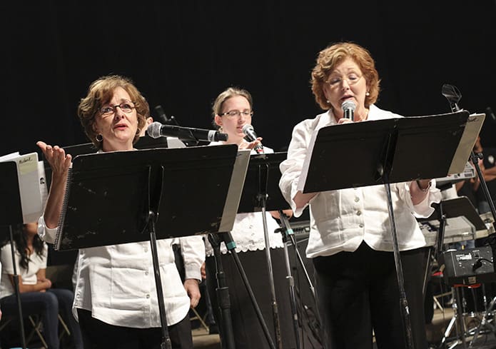 (Foreground, l-r) Vocalists Elyse O’Kane, left, and Mary Welch Rogers sing during Benediction of the Blessed Sacrament. Photo By Michael Alexander