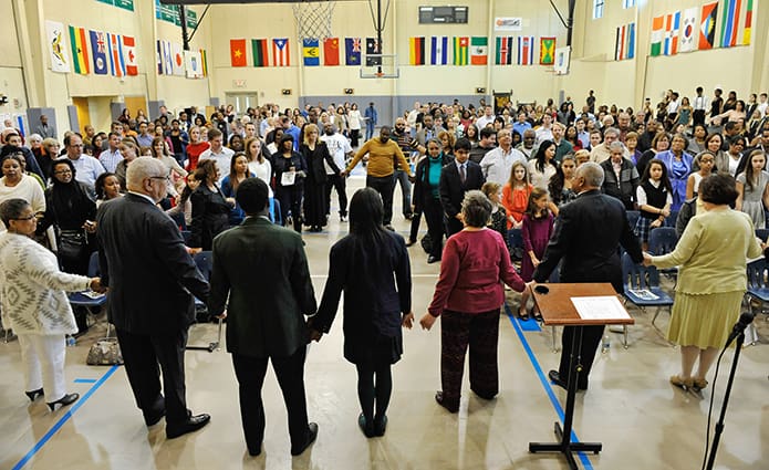 The MLK Youth Celebration, held Jan. 18 at St. Peter Claver Regional School, ended with a final blessing from Archbishop Wilton D. Gregory and the singing of “We Shall Overcome” by the assembly.  Attending the celebration were Charles O. Prejean, second from left, retiring director of the Office for Black Catholic Ministry, Archbishop Gregory, second from right, and Diane Starkovich, Ph.D., right, superintendent of Catholic Schools. Photo By Lee Depkin