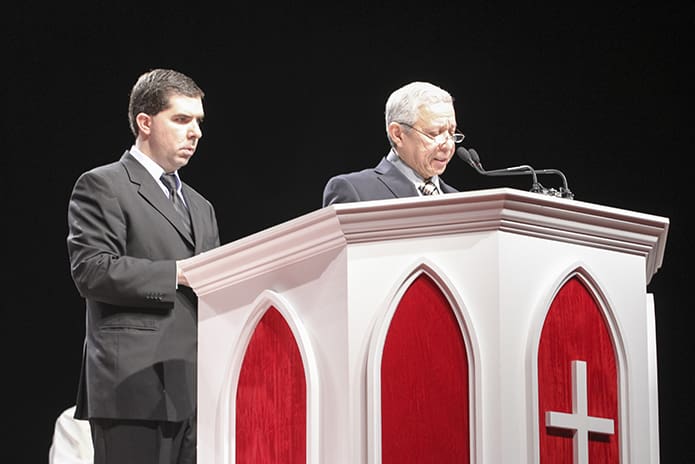 Leonardo Jaramillo, left, director of religious education for Our Lady of the Americas Mission in Lilburn, looks on as RCIA coordinator Armando Narvaez reads off the names of the missionâs 105 catechumens. The mission also had 117 candidates. Photo By Michael Alexander