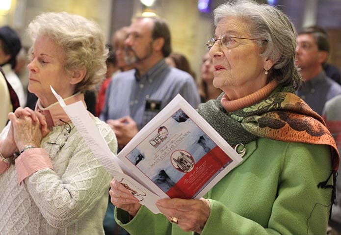 (R-l) Sylvia Fallon and Penny Krautter of Our Lady of the Assumption Church, Atlanta, stand for the Liturgy of the Eucharist during the 26th annual Mass for the Unborn at the Cathedral of Christ the King, Atlanta.