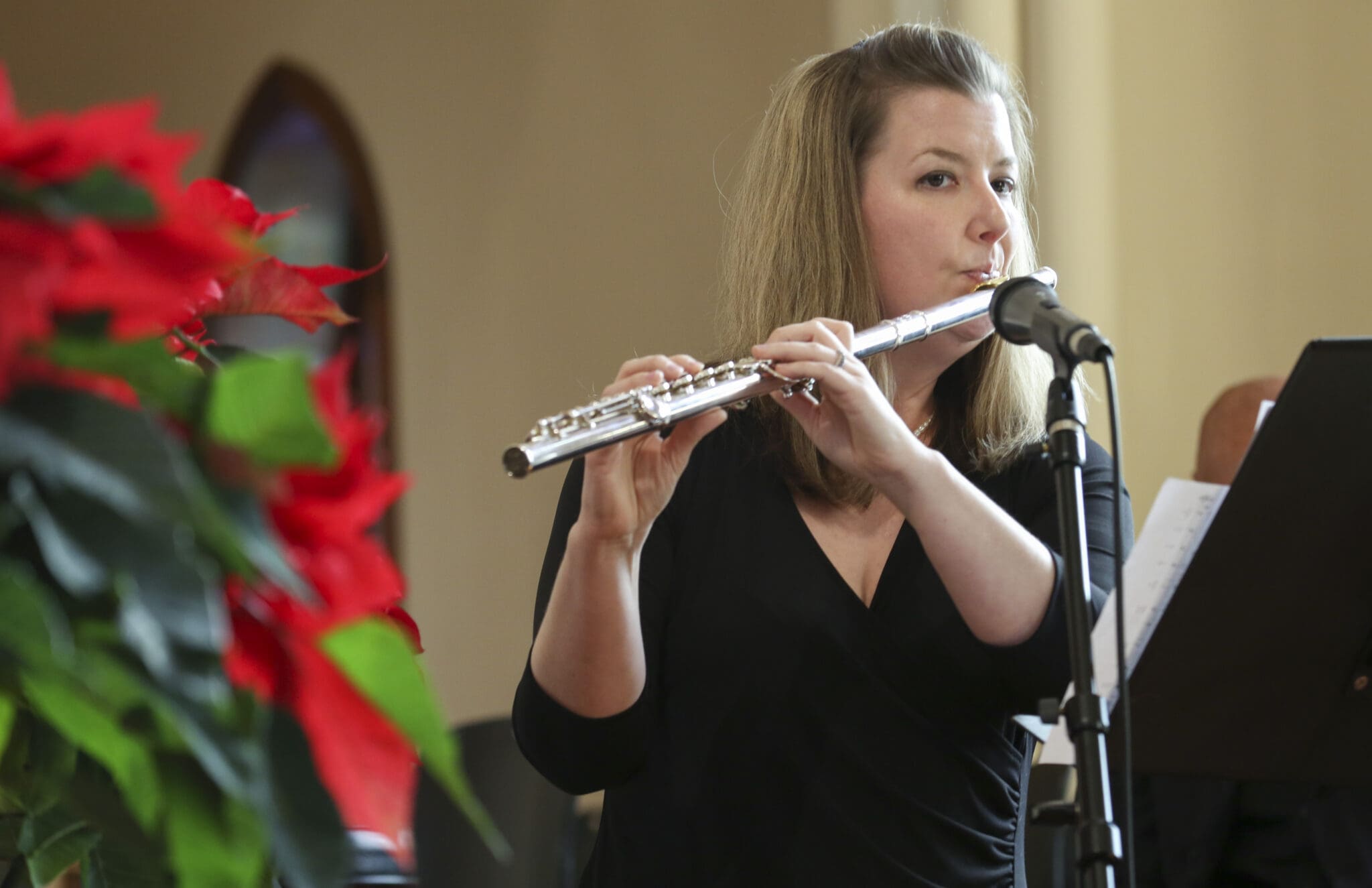 During a musical prelude prior to the Mass, Margaret Peterson of St. Philip Benizi Church, Jonesboro, performs the James Weldon Johnson composition “Lift Every Voice and Sing.” The parish director of music, Nicholas Dragone, accompanied her on piano. Photo By Michael Alexander