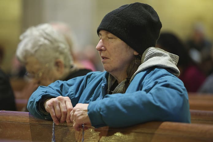 Jane Connelly Goodwin of Holy Cross Church, Atlanta, joins the congregation in praying the sorrowful mysteries of the rosary prior to the Mass for the Unborn. Photo By Michael Alexander