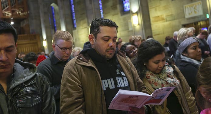 (L-r) Aurelio Velazquez, Everardo Gamboa and Jerendy Zamora of St. George Church, Newnan, stand during the Prayers of the Faithful at the Jan. 22 Mass for the Unborn. Photo By Michael Alexander