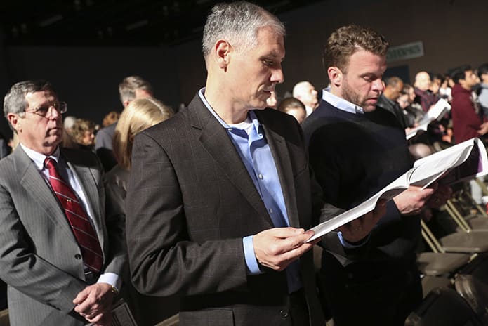 Sam Cicogna, center, serves as a sponsor for St. Brigid Church candidate Jamison Roden, right. Immediately behind them is Donald Young, left, a catechumen from St. Vincent de Paul Church in Dallas. Photo by Michael Alexander