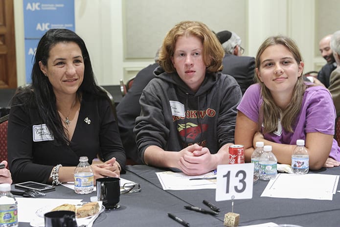 (L-r) Carmen Luisa Coya-van Duijn of the Atlanta Archdiocese, Brendan Harrison and Lauren Wright participate in a table dialogue after a talk by Rabbi Scott Colbert, the rabbi emeritus at Temple Emanu-El in Sandy Springs. Photo By Michael Alexander