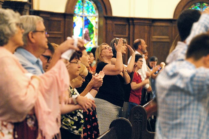 Judie Zervic, an interpreter with the deaf ministry at Transfiguration Church, Marietta, signs the Our Father at the Faith and Sharing Mass of Inclusion at Holy Spirit Church, Atlanta, Sept. 2. The Mass marked the 40th anniversary of the “Pastoral Statement on Persons with Disabilities” released by the U.S. Conference of Catholic Bishops in November 1978. PHOTO BY LAURA MOON.