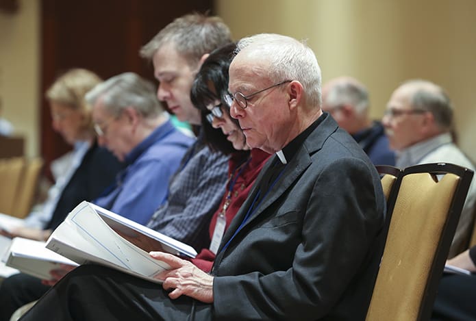 (Front to back) Father Dan Fleming, pastor of St. Andrew Church, Roswell, Susanna Weatherholt, a member of the liturgy committee at St. Andrew Church, and Philip Barreca, St. Andrew Church director of music, join others for morning prayer during day two of the 49th annual National Meeting of Diocesan Liturgical Commissions. Photo By Michael Alexander