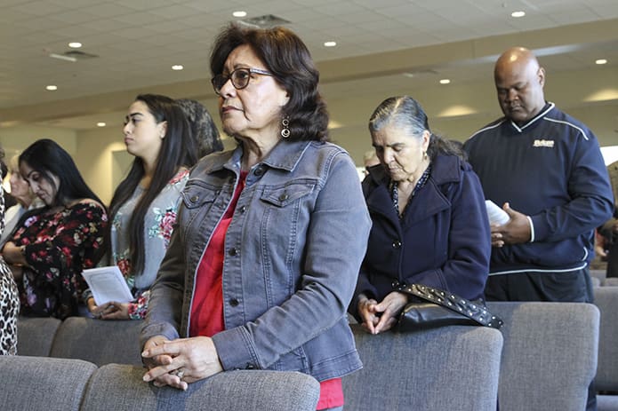 Maria Grimaldo, foreground, joins other members of the congregation during the special dedication Mass for St. Clare of Assisi Church, Acworth. Photo By Michael Alexander