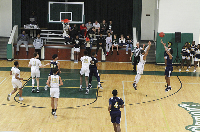 Cristo Rey Atlanta Jesuit High School guard Ibrahim Bass, right, shoots a three-point field goal over Holy Spirit Preparatory School's Michaiah Jeremiah (#1) during the second half of the Dec. 14 game. It was three of Bassâ 10 points during the 77-35 loss to Holy Spirit Prep. Photo By Michael Alexander