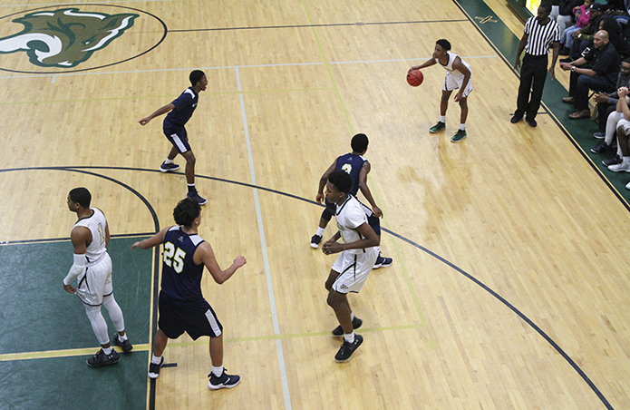 Holy Spirit Prep senior guard Miles Wallace, top right, sets up a play as his teammates move into position during the final period of the game. Holy Spirit Prep defeated Cristo Rey Atlanta 77-35. Photo By Michael Alexander