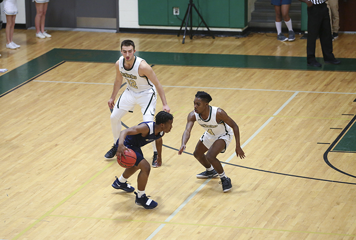 Cristo Rey Atlanta guard Omario Knox tries to maneuver around a double-team by Holy Spirit Prep's Buka Peikrishvilli (#32) and CeDaniel Sumpter (#4). Photo By Michael Alexander